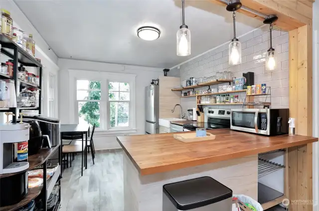 Unit 3 - Main Kitchen area features butcher block counters, modern updates and stainless steel appliances.