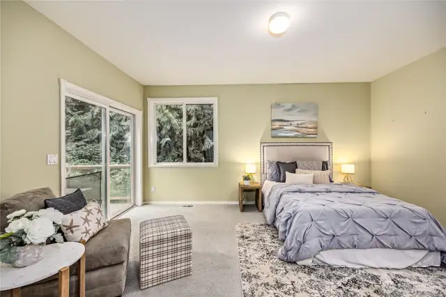 Primary bedroom with room for sitting area and doors out to the deck.