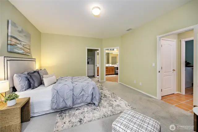 Primary bedroom with view into the ensuite bath and walk-in closet.