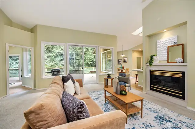 Living area with the entrance to the expansive deck. Sunroom to the left.