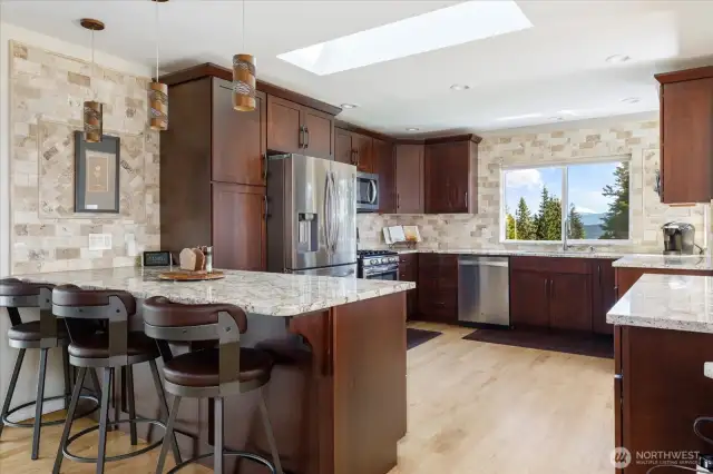 Welcoming kitchen with eating space and cherry wood cabinets.