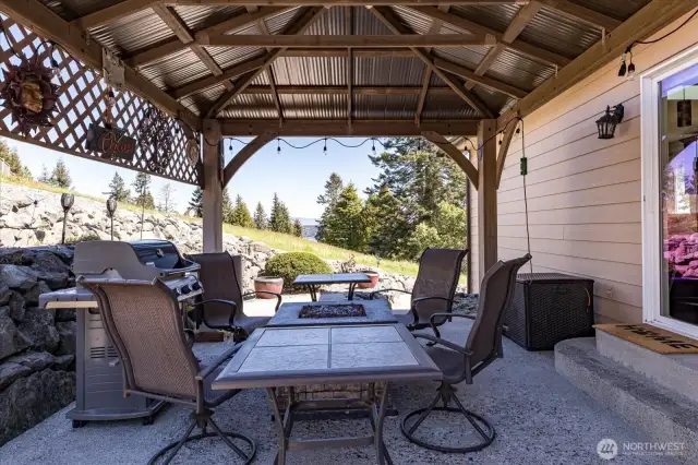 Covered patio with a gazebo, fireplace, and awning—perfect for relaxing or entertaining.