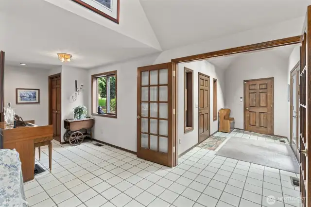 Grand entryway with elegant French doors leads into the main living area