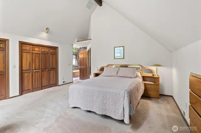 Private main suite with built-in wall dresser and drawer storage and updated ensuite bath