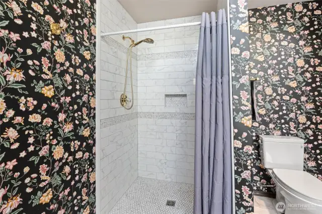 Updated ensuite five-piece bath with new tile shower and waterproof laminate tile flooring