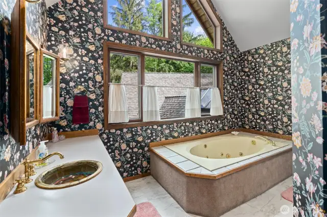 Ensuite five-piece bath with soaking tub. Updated with and waterproof laminate tile flooring.