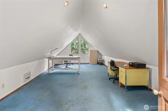 Bonus room above the attached garage, featuring a separate entrance with a dutch door and it's own wall heater