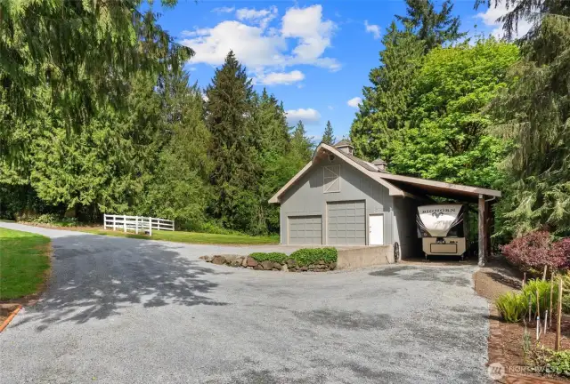1,144 sq ft detached garage/shop with covered RV parking for up to 48' RV, with power and hookups