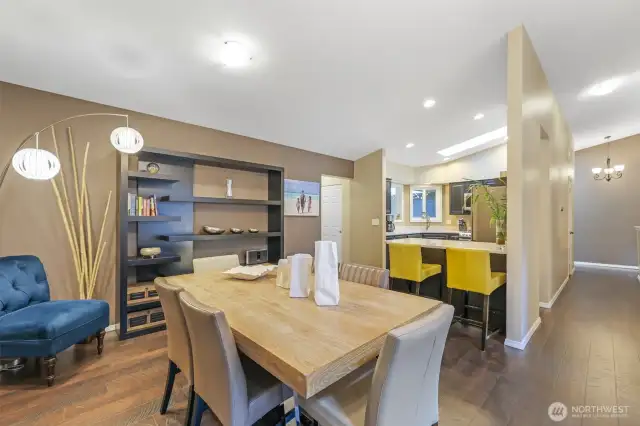 The open-concept layout connects the dining area and kitchen, creating a seamless space for everyday living and entertaining. The adjacent breakfast bar invites casual dining and conversation.