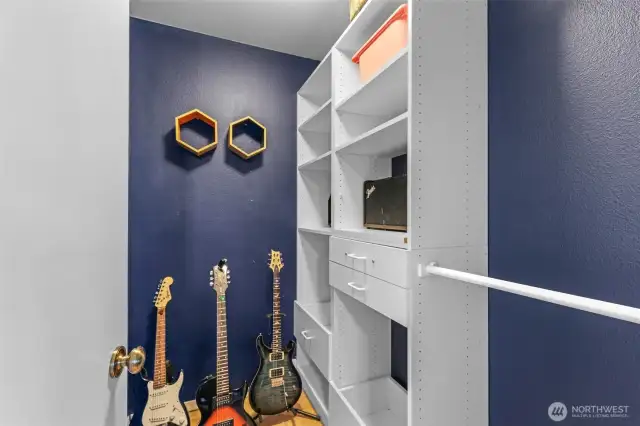 A walk-in closet connected to the large secondary bedroom adds convenient storage with a built-in organizing system, maximizing space and keeping items easily accessible.