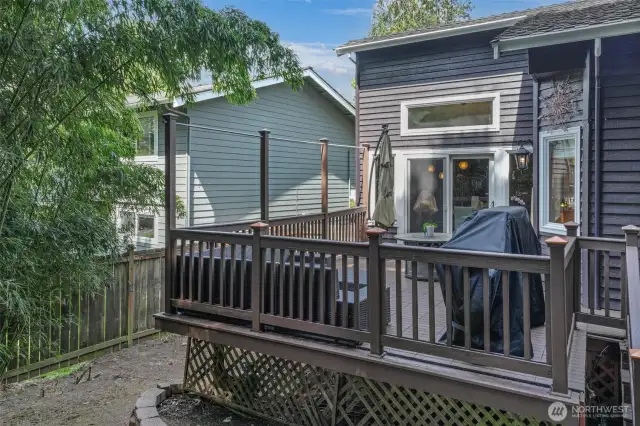 An elevated perspective highlights the spaciousness of the back deck and its relationship to the fully fenced yard. Whether hosting friends or enjoying a quiet evening, this outdoor area adds valuable living space.