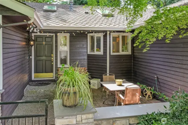 The gated courtyard entry adds both charm and security, leading to a covered front porch ideal for greeting guests. Skylights above the entry allow natural light to flow inside, setting the tone for the bright and welcoming interior.