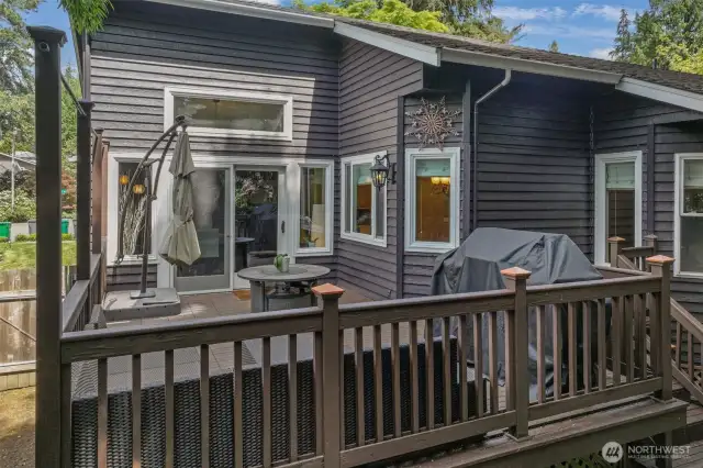 French doors open to an expansive deck, offering a seamless flow from the dining room to outdoor living. Whether enjoying quiet mornings or lively gatherings, this space is a true extension of the home.