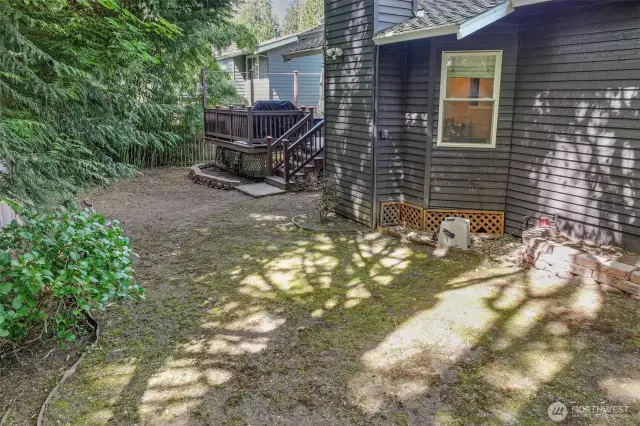 Step down from the deck into a spacious backyard shaded by mature trees. With plenty of room to expand a garden or create a custom outdoor space, the options here are endless.