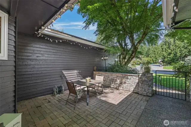 Enjoy a peaceful morning or evening in the private front patio, enclosed by a stone-accented retaining wall and surrounded by natural foliage. This functional outdoor space offers a serene transition between indoors and out.