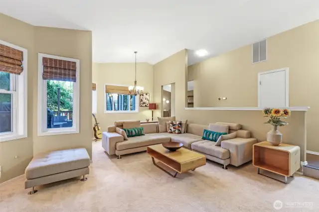 Multiple windows frame views of the surrounding landscape, while the open layout creates seamless flow for entertaining or daily living. Freshly installed carpet adds softness and comfort underfoot.