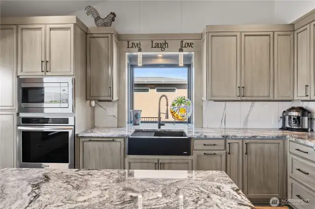 Kitchen with granite countertops and custom cabinetry.