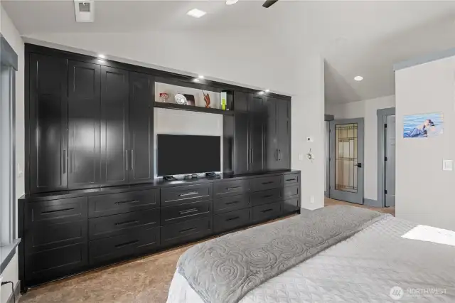 Primary bedroom with built-in cabinets and drawers.