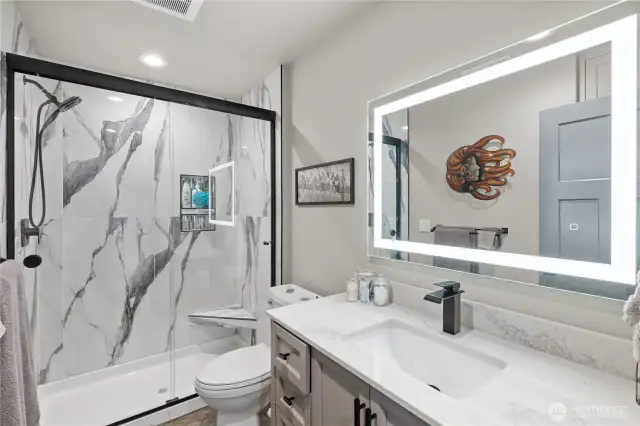 Main bathroom with tile walk in shower.