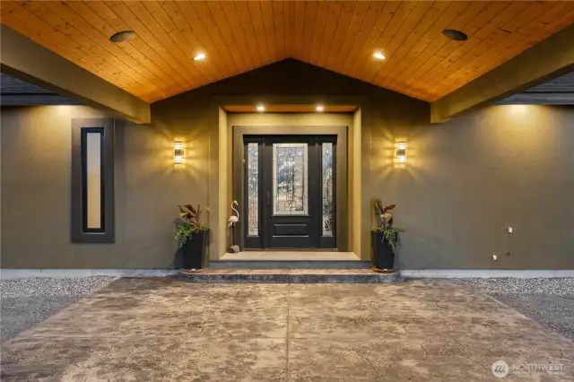 Covered front entry with stamped concrete.