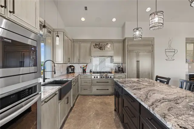 Kitchen with top of the line stainless steel appliances, sub zero refrigerator and warming over.