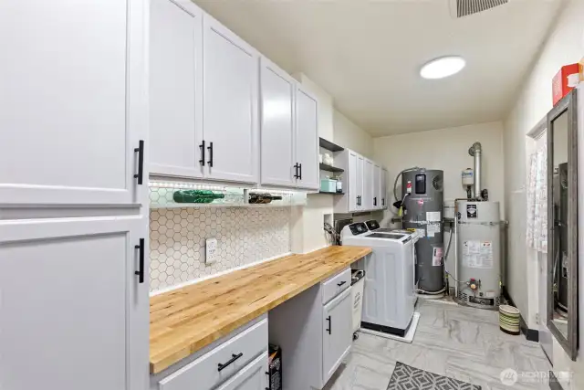 The utility room has all the functions needed to make laundry not even feel like a chore. There is even a brand  new Rheem 80-gallon high-efficiency heat pump water heater.