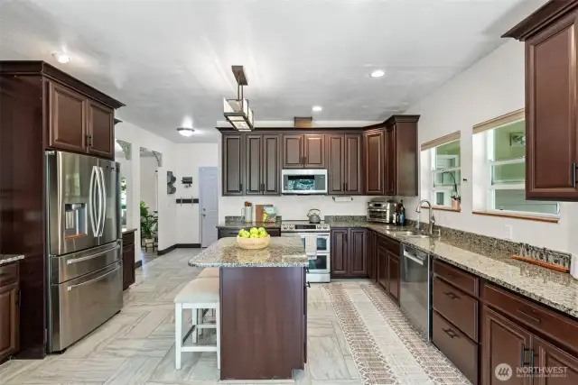 Large spacious kitchen with plenty of cabinet storage and granite countertop space. Stainless steel appliances that all convey.