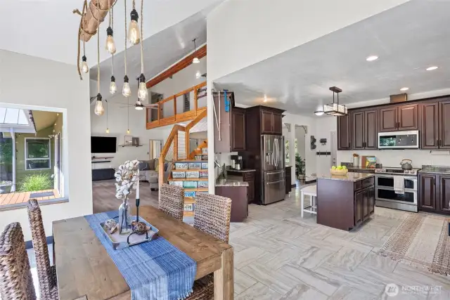 View of the kitchen, dining, and living area shows how this home can be used for entertaining and is thoughtfully designed.