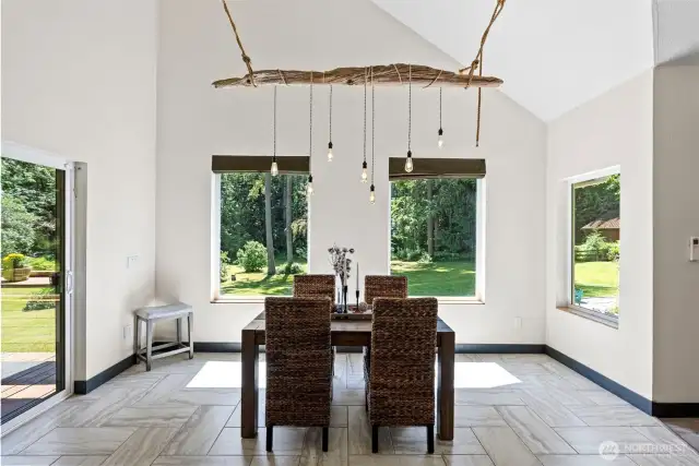 Beautiful driftwood chandelier handcrafted by the owner accentuates this dining space.