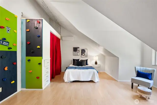 Guest room 1 comes equipped with a Seahawks rock wall that leads to a hidden loft area. What fun!