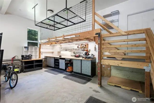 The garage also features a 20-foot premium workbench below the mezzanine, offering fantastic workspace and organization options while still allowing for full two-car parking.
