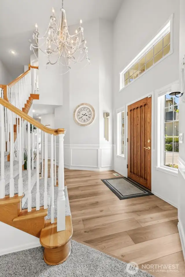 Light-filled interiors featuring high ceilings, oversized windows, and gorgeous chandelier.