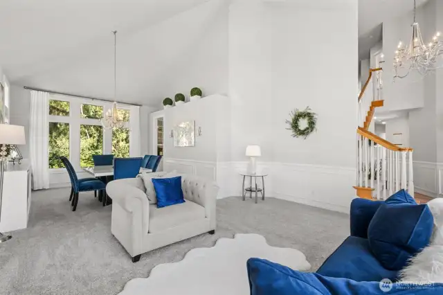 Open Concept Living & Dining - immaculately maintained open-concept living and dining space with designer touches throughout. Enjoy crisp white walls, statement lighting, and garden views from nearly every angle—ideal for gatherings or quiet evenings at home.