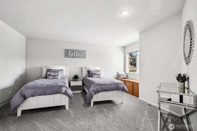 Spacious Guest Room with Twin Beds. Bright and airy guest bedroom featuring plush carpeting, neutral tones, and a cozy built-in window bench. Ideal as a shared kids’ room, guest suite, or flexible space for multi-generational living.