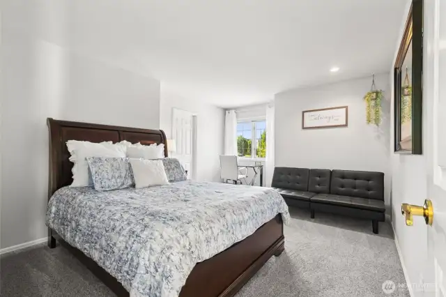Versatile Bedroom with Sitting Area. This generously sized bedroom includes a classic sleigh bed, ample natural light, and a dedicated seating or office nook—perfect for remote work or relaxation. A welcoming retreat for guests or family.