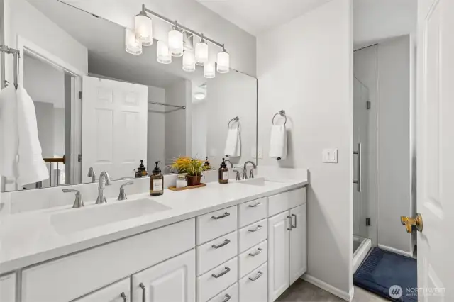 Updated Bathroom with Dual Vanities - Crisp and modern full bathroom featuring double sinks, sleek quartz counters, updated fixtures, and a walk-in glass shower. A perfect blend of functionality and style for shared or guest use.