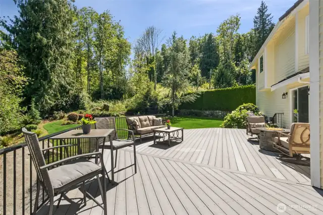 Entertainer’s Dream Deck Overlooking Lush Greenbelt. Expansive composite (TREX) deck offers multiple seating areas, perfect for outdoor dining, relaxing by the fire pit, or hosting summer gatherings—all surrounded by mature trees and serene privacy.