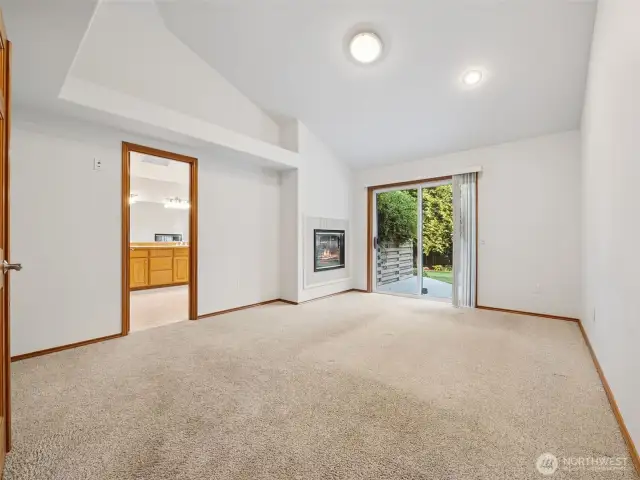 Primary Bedroom (on Main) w/ Deck Access, 5-piece en-suite, walk-in closet & fireplace
