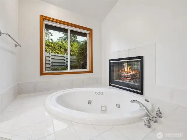 Primary 5-piece ensuite with soaking tub & fireplace