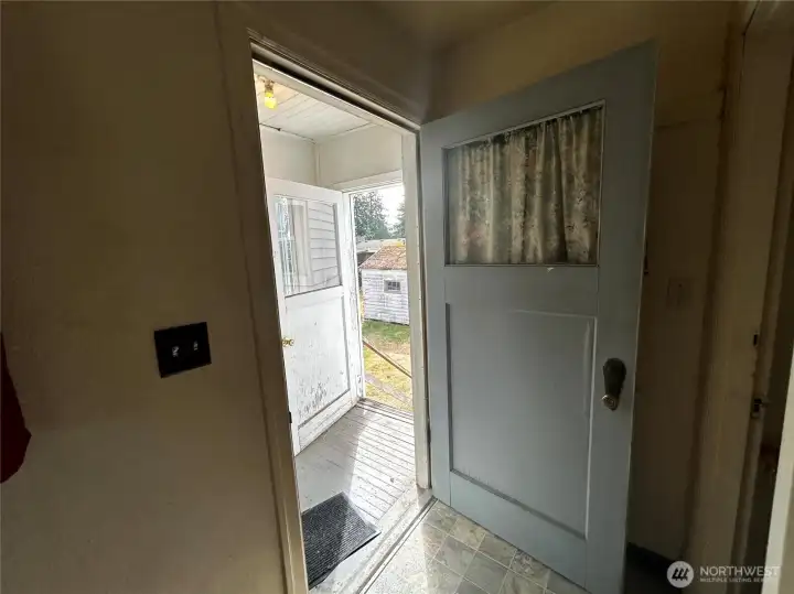 Back door, entrance to basement to the right