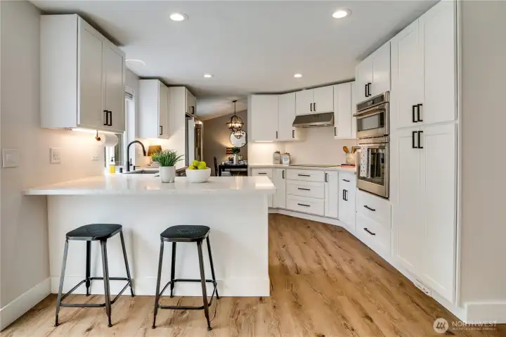 All new, high quality appliances fit right in with this open, eat-in kitchen's new cabinets and quartz countertops.