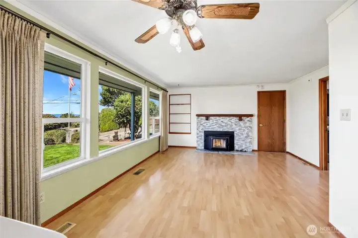 FAMILY ROOM  Wood burning certified fireplace insert with wood mantle, marble surround, and tile hearth  Built-in shelf / Ceiling fan