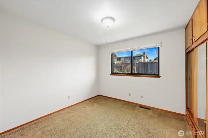 BEDROOM #2  Original hardwoods under carpet  Windows with views of rear yard   Floor to ceiling built in closet with storage cabinets