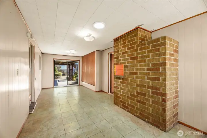 BONUS / FLEX ROOM  Door to slider to rear, and to garage with small doggy door  Vinyl tile floor / LOTS of built-in storage