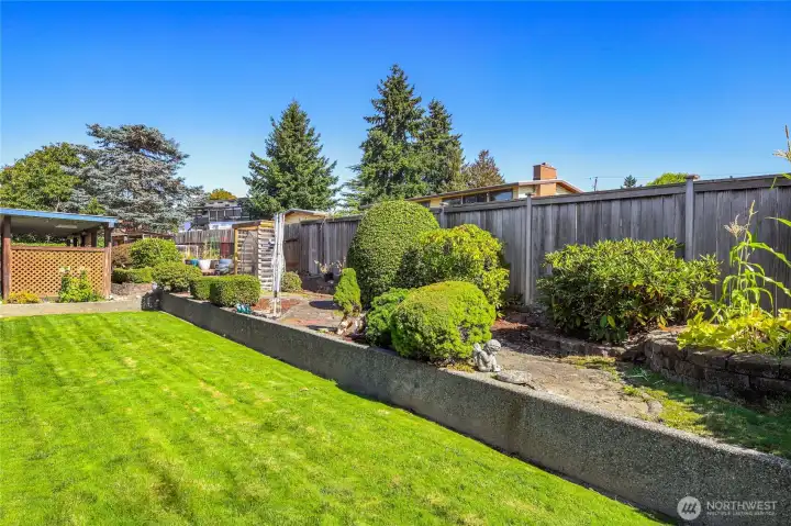 Whimsical design cement walking path  Sprinklers in front and back, with an 8-zone system / French drain