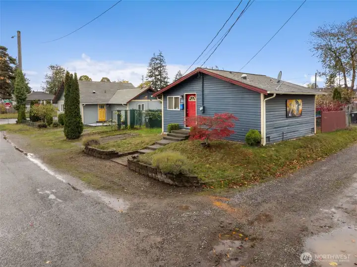 Plenty of parking both on property and off street. photo of cottage with main home in the distance.