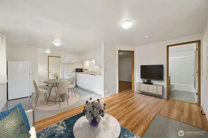 Open-concept living room, dining area, and kitchen designed for convenience.