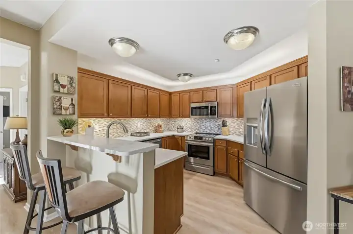 The updated kitchen is truly a Chef’s Kiss with new quartz counters, custom backsplash, under    cabinet lighting and newer stainless-steel appliances.