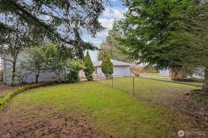 Backyard has a fence separating the right unit from the left. There is a man-gate to get from one side to the other. Beautiful shade trees; can be limbed up some to add more sunlight.