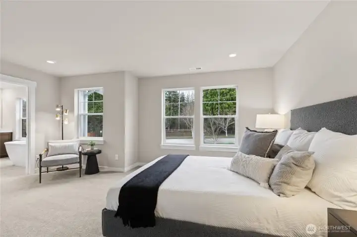 Primary bedroom with 5-piece attached bathroom and walk-in closet. Materials, colors, and finishes will vary. See site agent for details